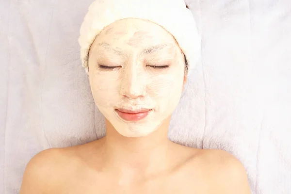 beautiful asian woman relaxing in the spa salon, getting skicare treatment