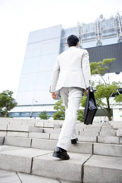 young businessman walking on the stairs outdoors