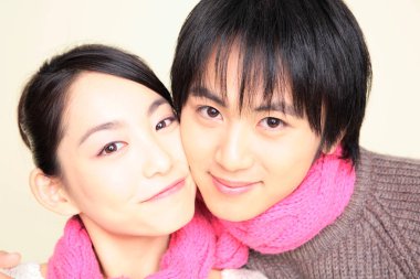 Closeup portrait of Japanese loving couple in winter sweaters clipart