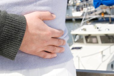 Çift deniz manzarasında iskelede sarılıyor. 