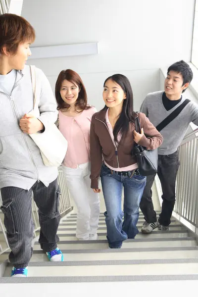 Cheerful Japanese students in university corridor