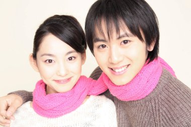 Closeup portrait of Japanese loving couple in winter sweaters clipart