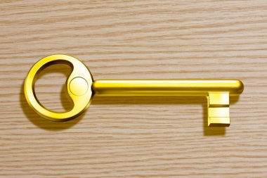 Ahşap arka planda altın anahtar