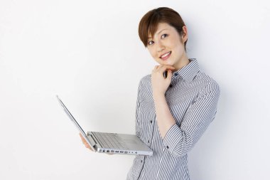 Beyaz arka planda dizüstü bilgisayar kullanan Asyalı kadın