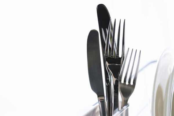 close up of forks and knives on white background