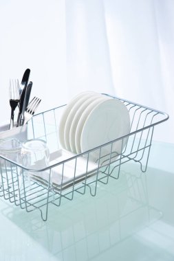 Temiz mutfak masasındaki bulaşık makinesinde temiz tabaklar.