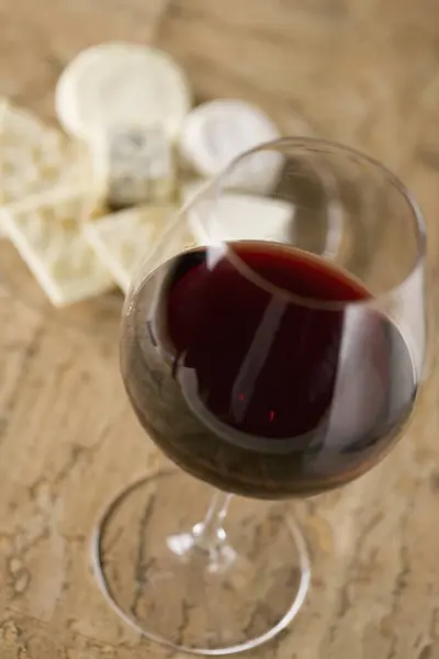glass with red wine on table, close up view