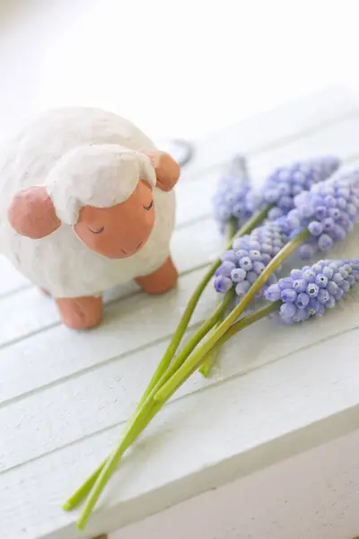 ラベンダーと木のテーブルの花束が付いているかわいい小さなおもちゃの羊 — ストック写真