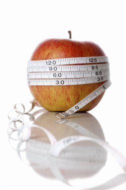 Beyaz arka planda elma ve mezura. Diyet kavramı