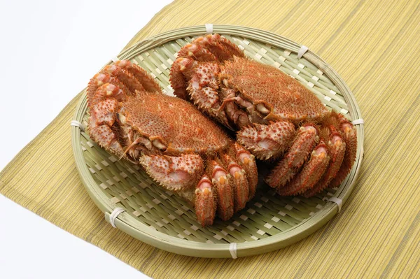 a cuisine photo of crabs on bamboo plate