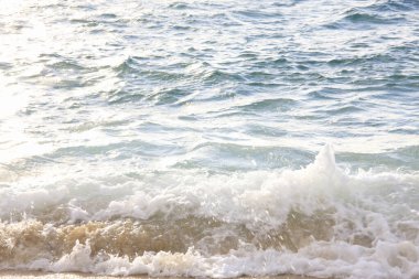 Deniz dalgaları kumlu sahile çarpıyor. seyahat, tatil kavramı