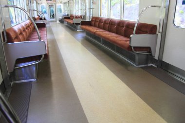 modern metro treni içi kırmızı yumuşak koltuklu.
