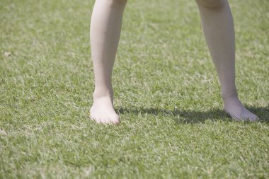 Parkta yeşil çimenli bir kız