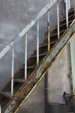 old metal stairs with a metal railing.