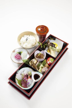 Birçok küçük tabakta çeşitli Japon yemeklerini gösteren mutfak fotoğrafı.