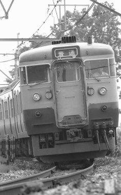 Tren raylar boyunca ilerliyor. siyah ve beyaz fotoğraf olay yerini yakalıyor.