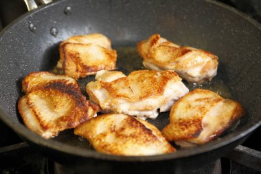 fried fish on a pan on  background, close up