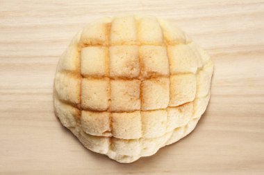 Sweet melon bread resting on wooden surface