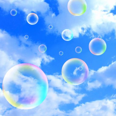 Mavi gökyüzü arka planında renkli sabun köpükleri    