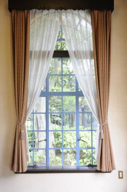 window with a white curtain on background, close up