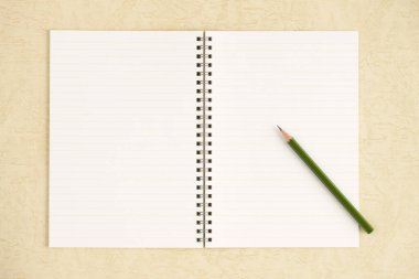 blank notepad and pencil on table, close up 