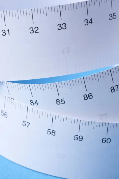 close-up view of tape measure on blue background