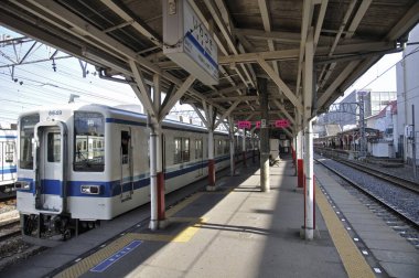 Mavi beyaz tren boş tren istasyonuna varıyor.