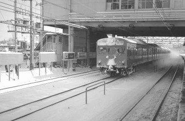 Japon demiryollarından geçen siyah beyaz tren görüntüsü.