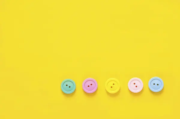 stock image top view of colorful buttons on yellow background   