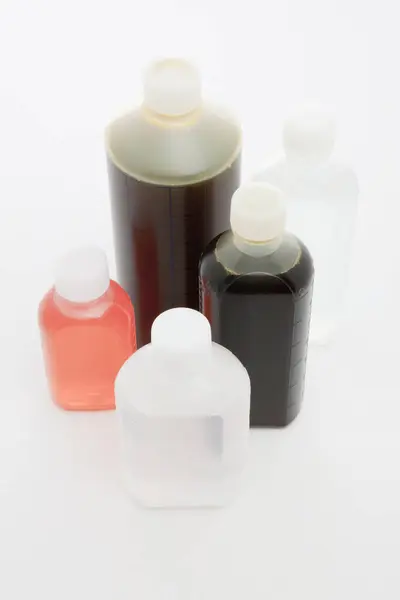 Close View Colored Plastic Bottles Liquid Light Background — Stock Photo, Image