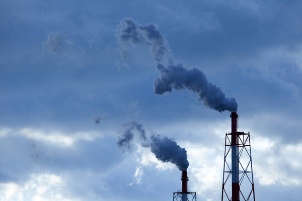 smoke from chimneys of industrial factory against sky       
