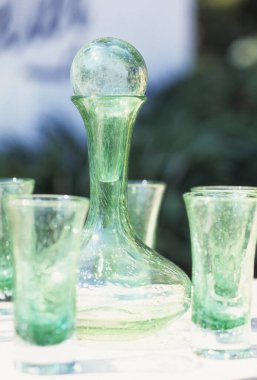 Masanın üzerinde su damlaları olan eski güzel cam eşyalar.