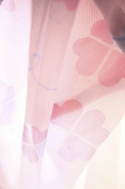 close up shot of a beautiful fabric with pink hearts
