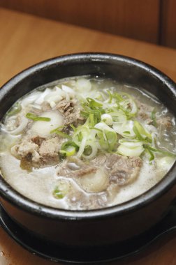 Lezzetli Asya yemeklerinin yakın görüntüsü. Etli çorba ve dilimlenmiş yeşil soğan. 