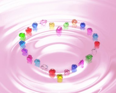 Pembe arkaplandaki renkli değerli taşlardan yapılmış kalp şekli