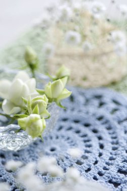 white roses in a glass bowl on blurred background