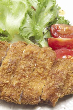 Crispy fried chicken served with salad