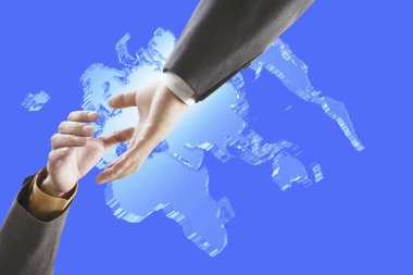 İş adamı arka planda dünya haritasıyla el sıkışıyor