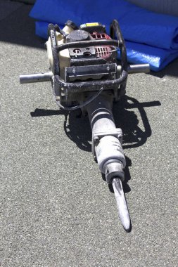 Sert asfalt yüzeyinde duran ağır sanayi matkabı.