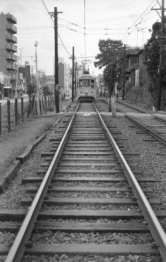 Japon şehrinde, gündüz görüşünde tren raylarından geçiyor. 