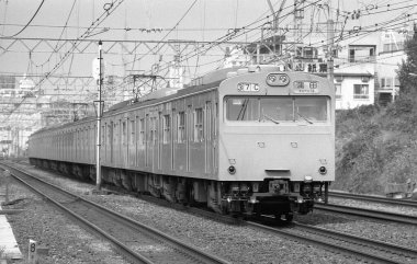 Trenle geçerken çekilmiş siyah beyaz bir sokak fotoğrafı. 