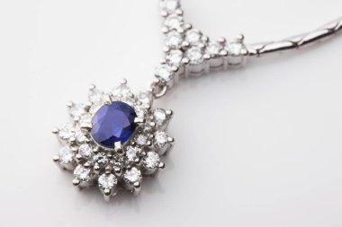 Beyaz üzerine elmas mücevher kolye, yakın plan.