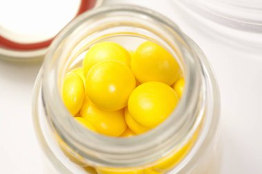 Arka planda haplarla dolu cam kavanoz.