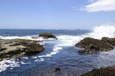 Dalgalar güzel kayalık kıyı şeridinde kırılıyor