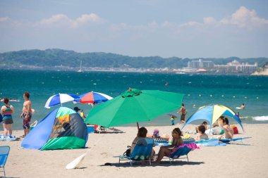 İnsanlar sahilde dinleniyor.