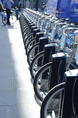 Şehir caddesinde park edilmiş modern bisikletler.