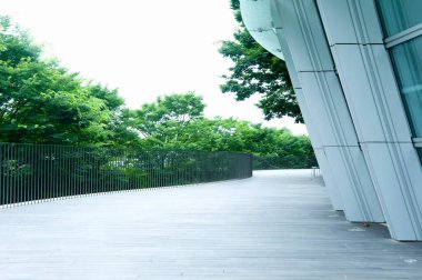 boş yürüyüş yolu, modern mimari ve şehirde yeşil ağaçlar