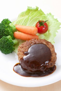 a cuisine photo of Matsusaka Beef with sauce and fresh vegetables clipart