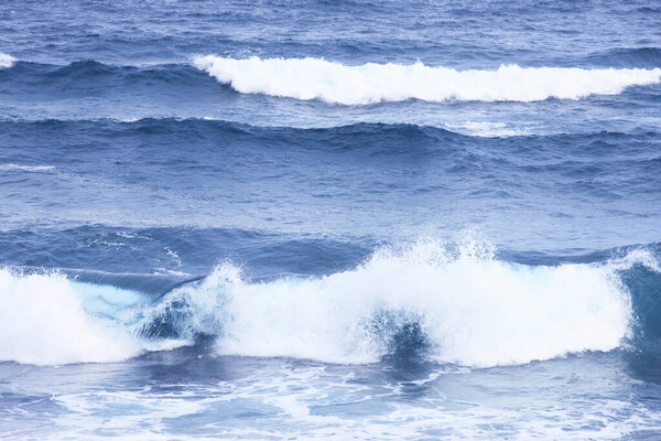 sea waves with foam crashing on beach 
