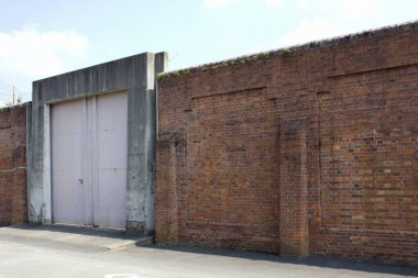 Kapısı ve mavi gökyüzü olan eski tuğla bina